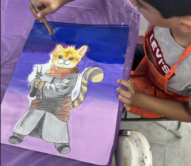 Beautiful cat painting by a boy